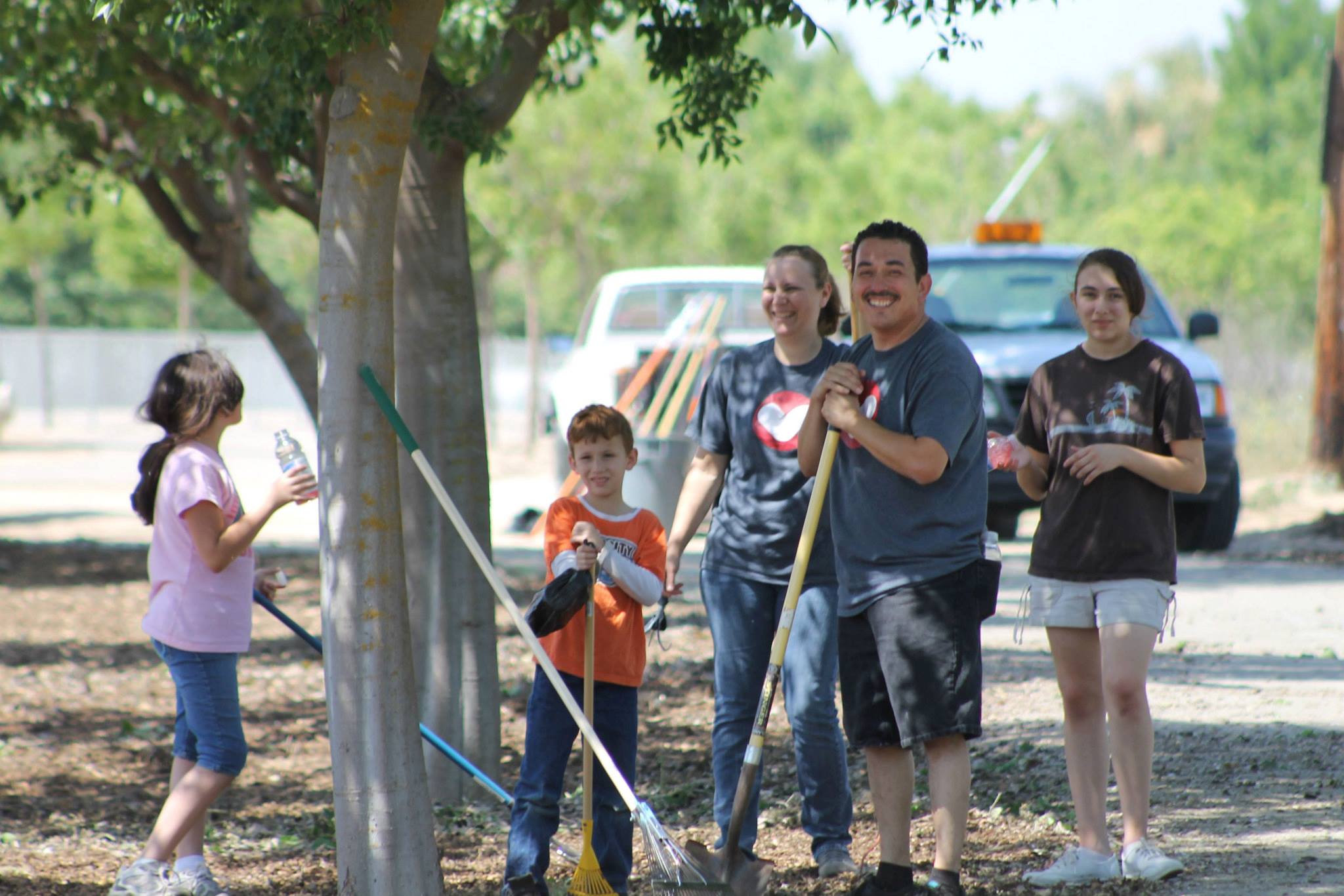 A group of volunteers work on cleaning up the river trail